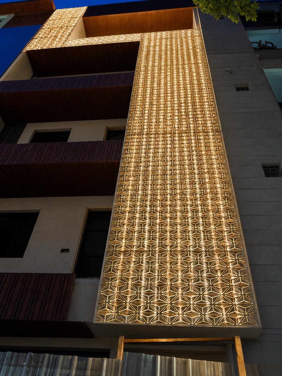 Meta Blossom: a building façade clad in sculpted gold aluminium panels whose petal-like folds catch the light across the elevation.