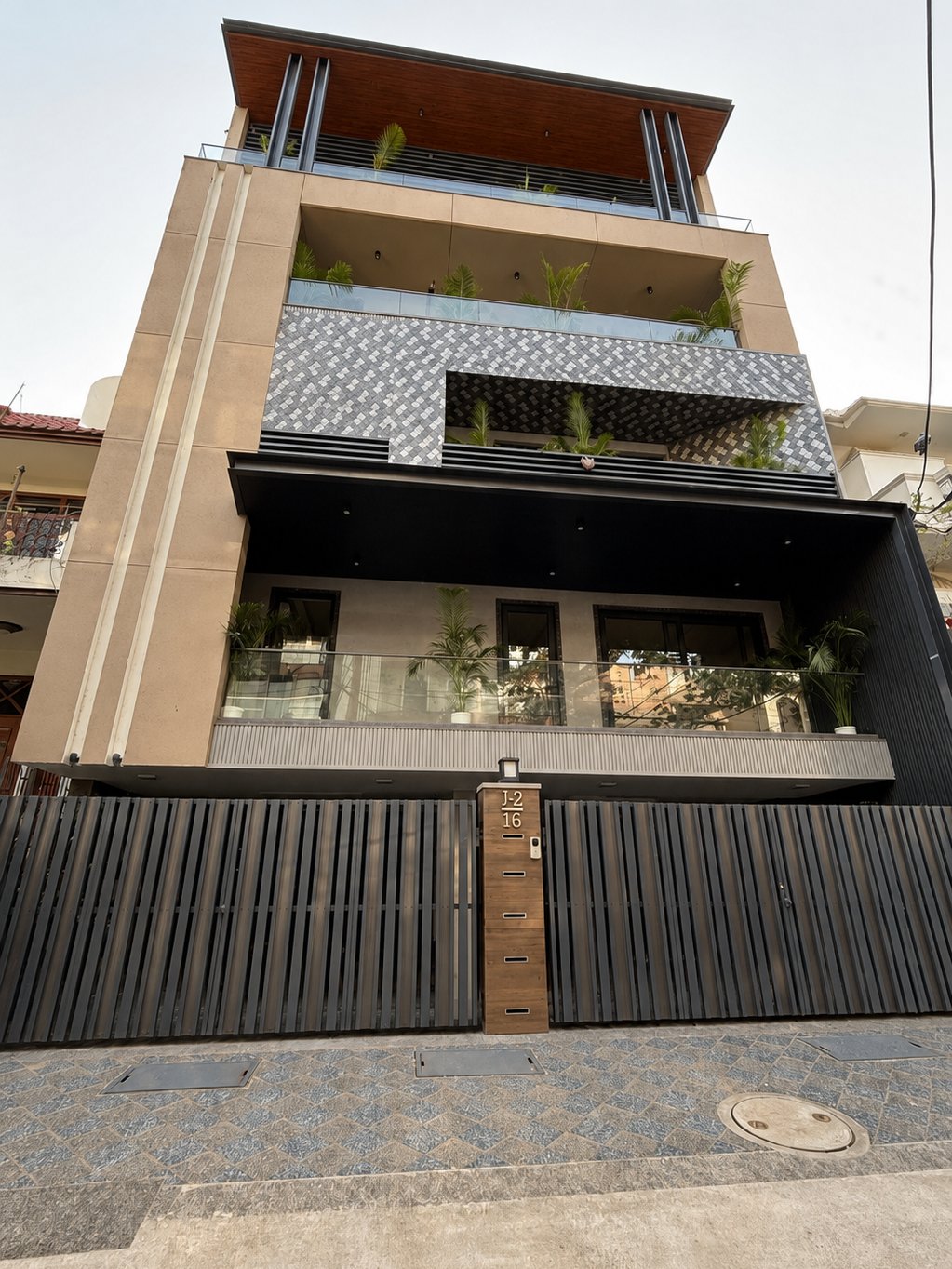 Meta Shingles: a building elevation layered with overlapping metal shingles that step across the surface like scales.